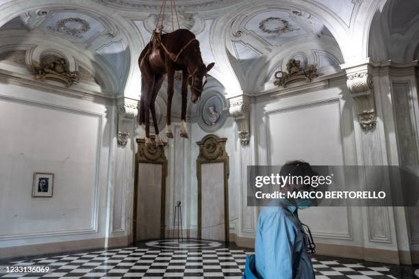 Man wearing a face mask visits "Novecento", an installation by Italian artist Maurizio Cattelan at the Museum of Contemporary Art "Castello di...