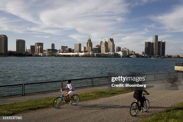 People cycle along the waterfront across from Detroit, Michigan, in Windsor, Ontario, Canada, on Wednesday, May 26, 2021. Nearly half of respondents...