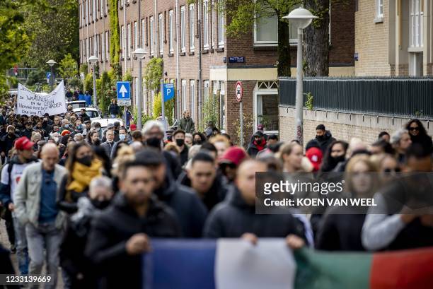 Victims' relatives and local residents march in silence through De Pijp quarter in Amsterdam, on May 27, 2021. - A 29-year-old man stabbed five...