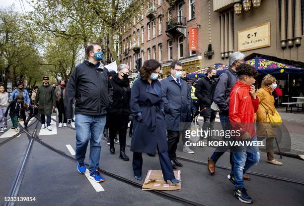 Mayor Femke Halsema walks along with victims' relatives and local residents in silence through De Pijp quarter in Amsterdam, on May 27, 2021. - A...