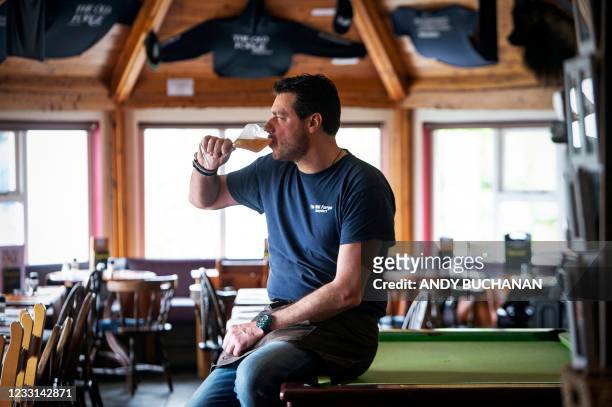 Jean-Pierre Robinet, owner of The Old Forge, poses for a photograph inside his pub in Inverie on the Knoydart peninsular in the Scottish Highlands on...