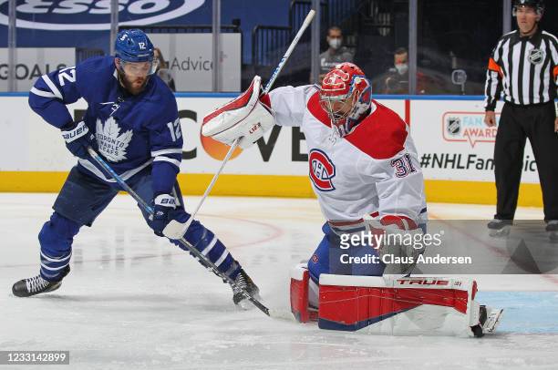Alex Galchenyuk of the Toronto Maple Leafs tries to tip a shot past Carey Price of the Montreal Canadiens in Game Five of the First Round of the 2021...