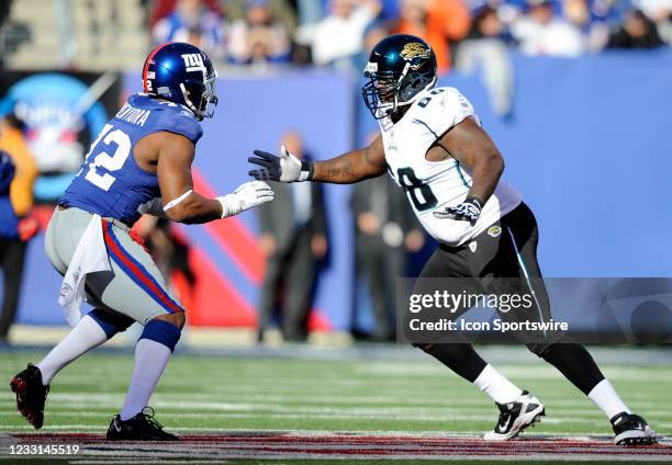 New York Giants defensive end Osi Umenyiora and Jacksonville Jaguars offensive tackle Guy Whimper during the game where the New York Giants hosted...