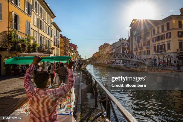 Street vendor sets up his stall in the Navigli neighborhood in Milan, Italy, on Thursday, May 27, 2021. Italy has approved a 40-billion-euro stimulus...