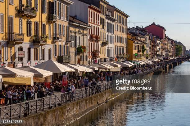 People stroll past restaurants along a canal in the Navigli neighborhood of Milan, Italy, on Thursday, May 27, 2021. Italy has approved a...