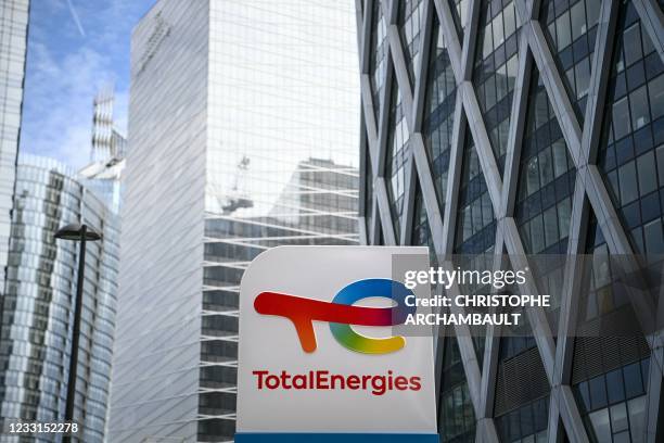 This photograph taken on May 28, 2021 shows the new TotalEnergies logo during its unveling ceremony, at a charging station in La Defense on the...