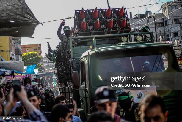 Members of the Izz al-Din al-Qassam Brigades, the military wing of Hamas display rockets during a military parade on the Streets in Khan Yunis,...