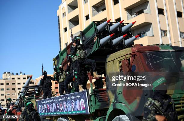 Members of the Izz al-Din al-Qassam Brigades, the military wing of Hamas display rockets during a military parade on the Streets in Khan Yunis,...