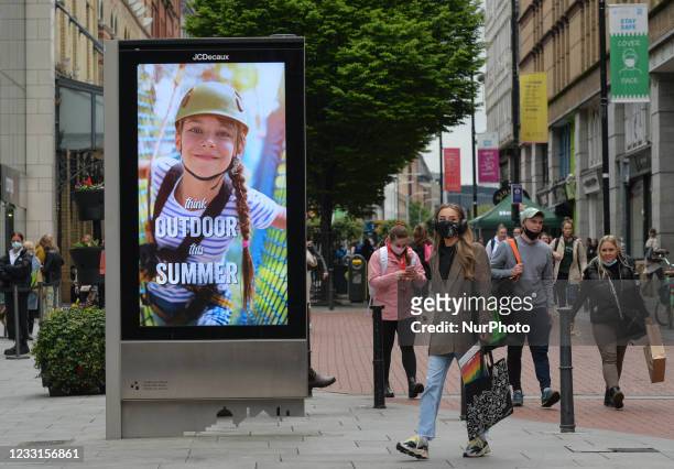 Street billboard with the words 'Think Outdoor This Summer' seen in the center of Dublin. The next stage of defrosting the Irish economy and easing...