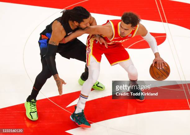 Trae Young of the Atlanta Hawks battles Derrick Rose of the New York Knicks in the first half during game three of the Eastern Conference...