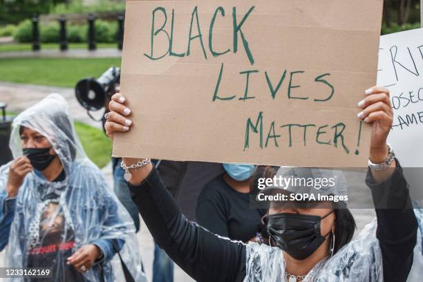 Jacqueline White, the ex-wife of DeWitt McDonald Jr., holds a Black Lives Matter sign in front of the Ohio Statehouse to advocate for DeWitt McDonald...