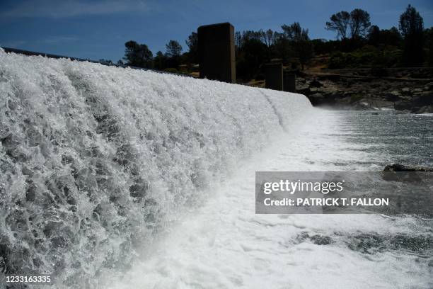 Water flows over the Feather River Fish Barrier dam as it diverts Chinook Salmon up a fish ladder to the California Department of Fish and Wildlife...