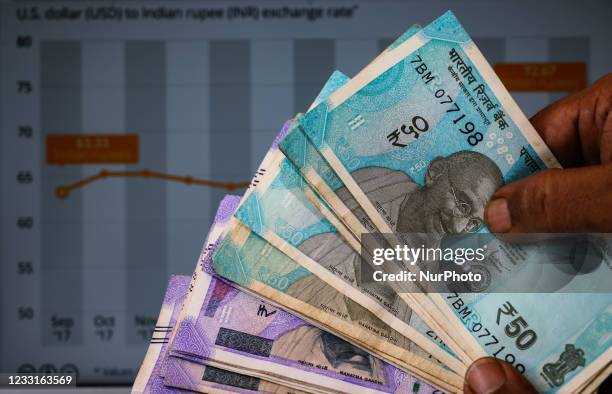 An indian man counts indian rupee currency in Tehatta, West Bengal, India on 29 May 2021. Indian currency rupee has staged a strong comeback,...