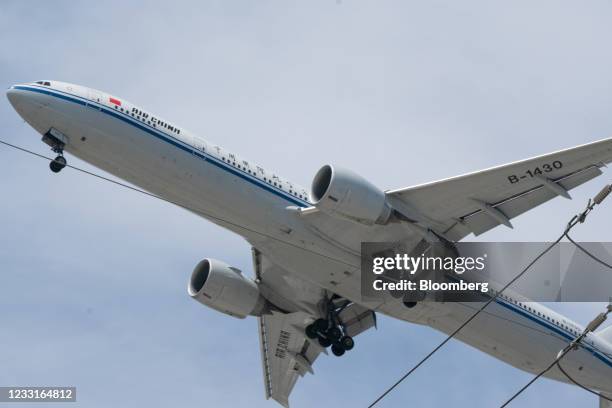 An Boeing 777-300 jetliner aircraft operated by Air China Ltd. Makes a descent into Los Angeles International Airport in Los Angeles, California,...