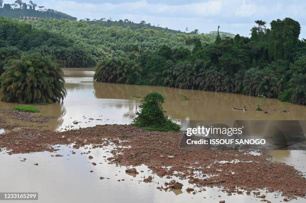 Picture taken on May 28, 2021 shows the low level of the water near Ayame hydroelectric dam, near Aboisso in Ivory Coast. - According to Ivorian...