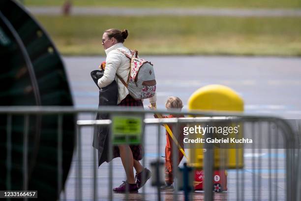 Employees of the Russian embassy in Prague and their families arrive to board a Russian government plane along with expelled Russian diplomats at...