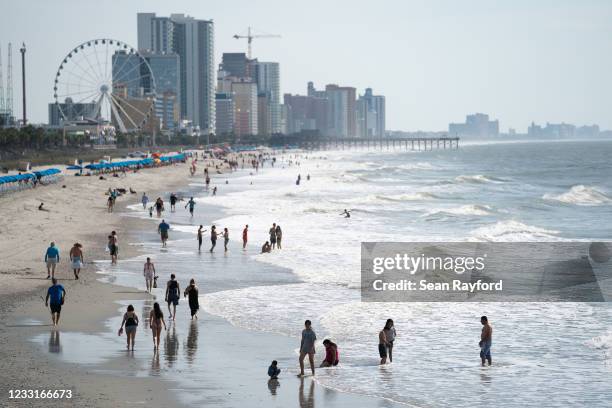 People walk along the beach the morning of May 29, 2021 in Myrtle Beach, South Carolina. Myrtle Beach is the No. 3 top destination for road trips on...