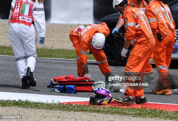 Medical officers clear the track as they evacuate Swiss Moto3 rider Jason Dupasquier in an helicopter after a crash during a qualifying session ahead...