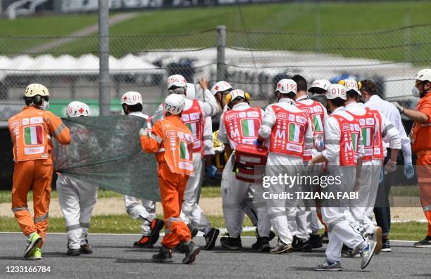 Medical officers evacuate Swiss Moto3 rider Jason Dupasquier in an helicopter after a crash during a qualifying session ahead the Italian Moto GP...