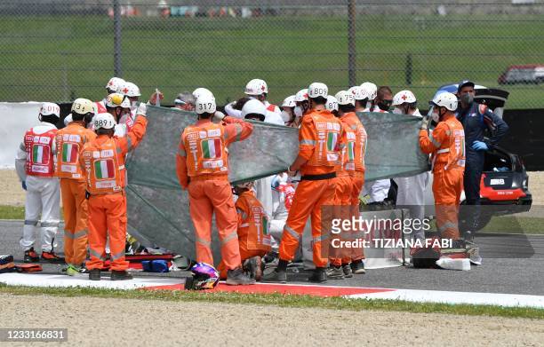 Medical officers tend to Swiss Moto3 rider Jason Dupasquier prior to an evacuation after a crash during a qualifying session ahead the Italian Moto...