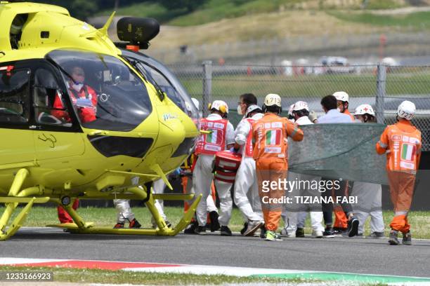 Medical officers evacuate Swiss Moto3 rider Jason Dupasquier in an helicopter after a crash during a qualifying session ahead the Italian Moto GP...