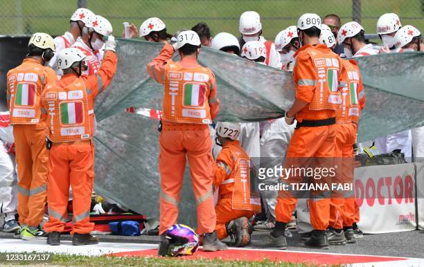 Medical officers tend to Swiss Moto3 rider Jason Dupasquier prior to an evacuation after a crash during a qualifying session ahead the Italian Moto...