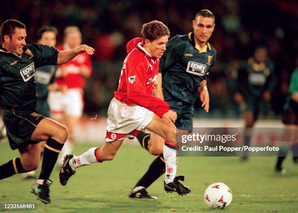 Juninho of Middlesbrough evades the challenge from Gary Elkins of Wimbledon as Vinnie Jones of Wimbledon looks on during an FA Carling Premiership...