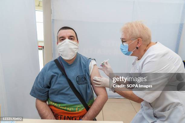 Healthcare worker administers a dose of Coronavac vaccine to a man at the Arena Lviv stadium. The new Center, the Arena Lviv stadium has been...