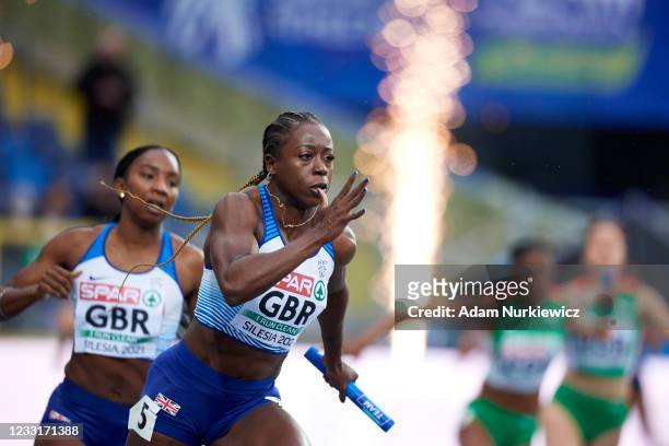 Desiree Henry runs with the baton after being handed it by Bianca Williams both of Great Britain compete in Women's Relay 4x100 meters during the...