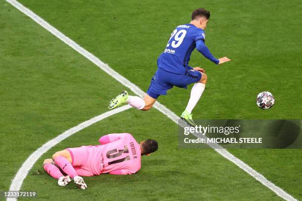 Chelsea's German midfielder Kai Havertz jumps over Manchester City's Brazilian goalkeeper Ederson to score the first goal during the UEFA Champions...
