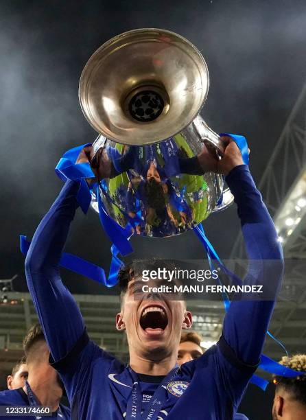 Chelsea's German midfielder Kai Havertz lifts the Champions League trophy after Chelsea won the UEFA Champions League final football match between...