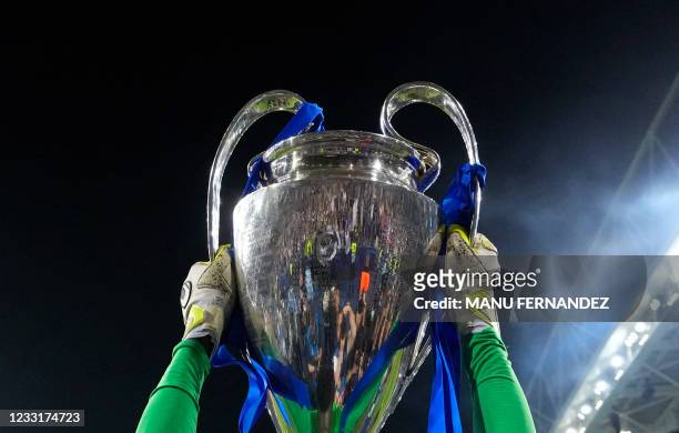 Chelsea's Senegalese goalkeeper Edouard Mendy lifts the Champions League trophy during the UEFA Champions League final football match between...