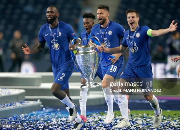 Chelsea's German defender Antonio Ruediger and Chelsea's Spanish defender Cesar Azpilicueta holds the Champions League trophy as they celebrate after...