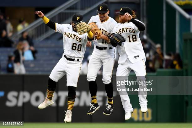 Ka'ai Tom of the Pittsburgh Pirates celebrates with Bryan Reynolds and Ben Gamel after the final out in a 4-0 win over the Colorado Rockies during...