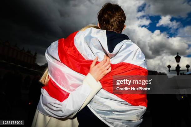 People demonstrate walking in the March of Solidarity with Belarus as part of the Global Solidarity Picket. Krakow, Poland on May 29, 2021. A...