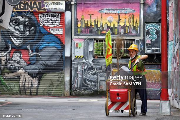 Worker cleans a street in Ximen, a commercial zone at the Wanhua District in Taipei on May 30, 2021.