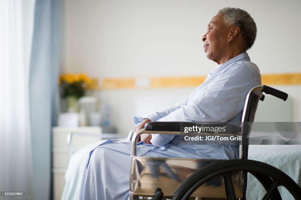 Black woman sitting in wheelchair in  hospital