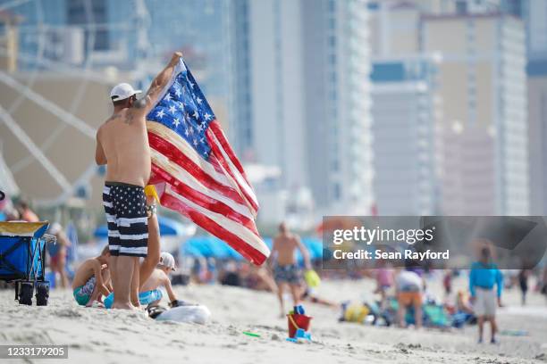 Beachgoer spreads out a patriotic towel on May 29, 2021 in Myrtle Beach, South Carolina. Myrtle Beach is the No. 3 top destination for road trips on...