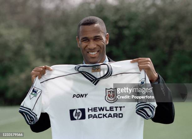 Footballer Les Ferdinand poses with the shirt after signing for Tottenham Hotspur from Newcastle United on July 28, 1997 in London, England.