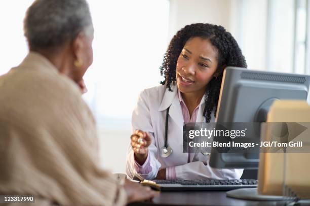 nurse talking to patient - cuban doctors stock-fotos und bilder