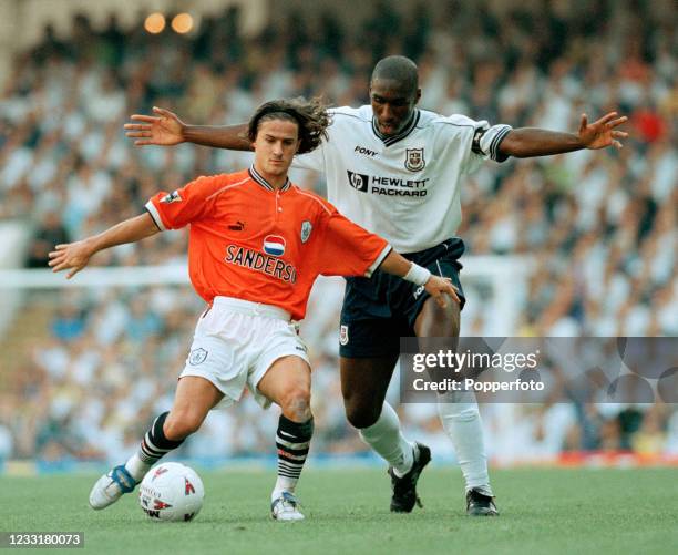 Benito Carbone of Sheffield Wednesday shields the ball from Sol Campbell of Tottenham Hotspur during an FA Carling Premiership match at White Hart...