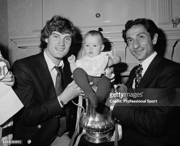 Tottenham Hotspur footballer Ossie Ardiles with his son and teammate Glenn Hoddle as they pose with the trophy at the Civic Reception following their...