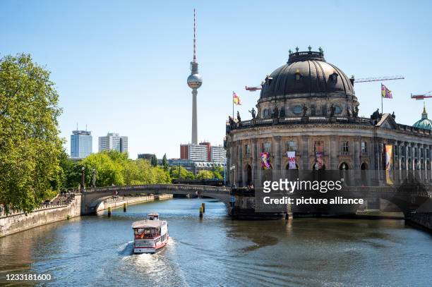 Ship sails on the Spree at the Museum Island. The relaxation of the Corona Ordinance in Berlin makes it possible that ""Historic City Tours" by Ship"...