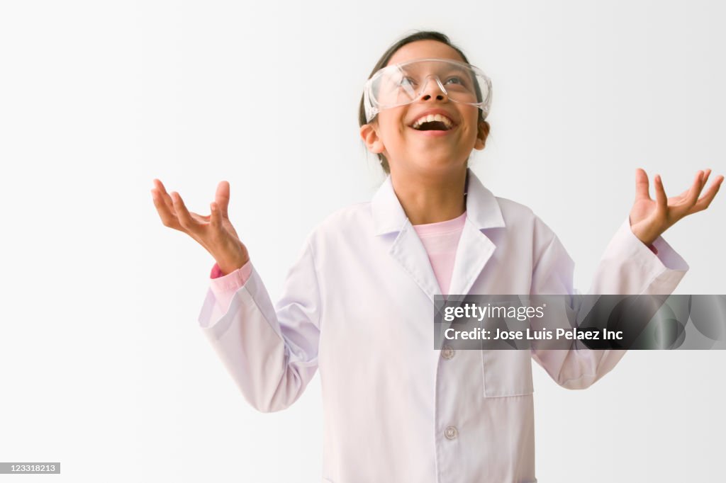 Frustrated Hispanic girl in lab coat looking up