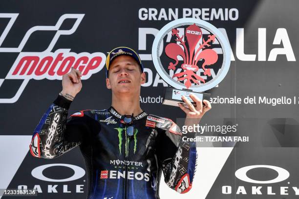 Yamaha French rider Fabio Quartararo celebrates with the winner's trophy on the podium of the moto world championship Italian Grand Prix MotoGP race...