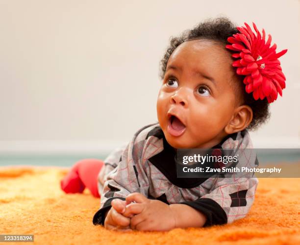 african american baby girl with red flower in her hair - girls glamour stock pictures, royalty-free photos & images