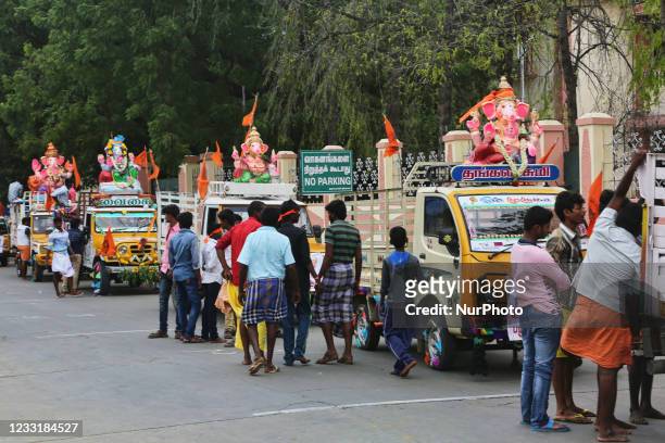 Tamil Hindu devotees attach large clay idols of Lord Ganesha to vehicles before journeying from the Ganesh temple to the ocean during the festival of...