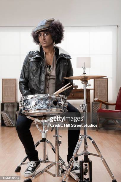 mixed race woman playing drums - african drum stock pictures, royalty-free photos & images