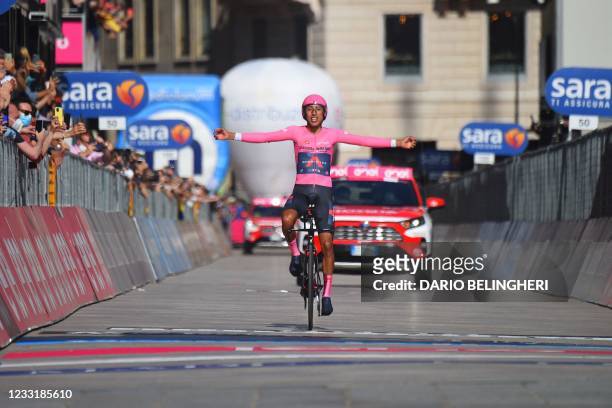 Overall leader Team Ineos rider Colombia's Egan Bernal celebrates as he crosses the finish line to win the Giro d'Italia 2021 cycling race, after the...