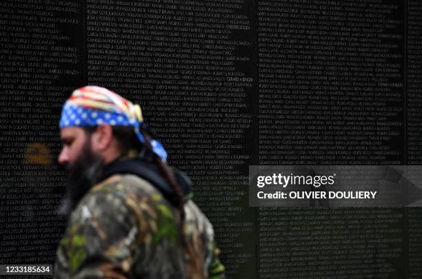 Veteran looks at the names of soldiers who lost their lives during the Vietnam War, on the Vietnam Veterans Memorial Wall, on May 30 in Washington DC.